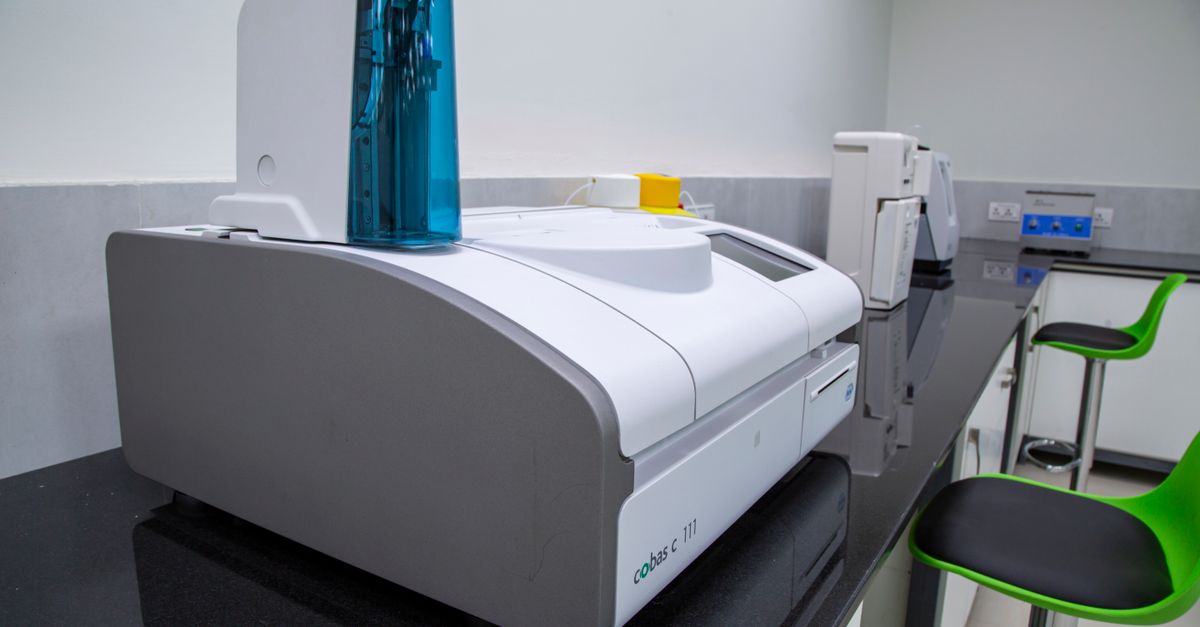 Sleek, modern laboratory equipment on a black countertop in a professional lab setting.