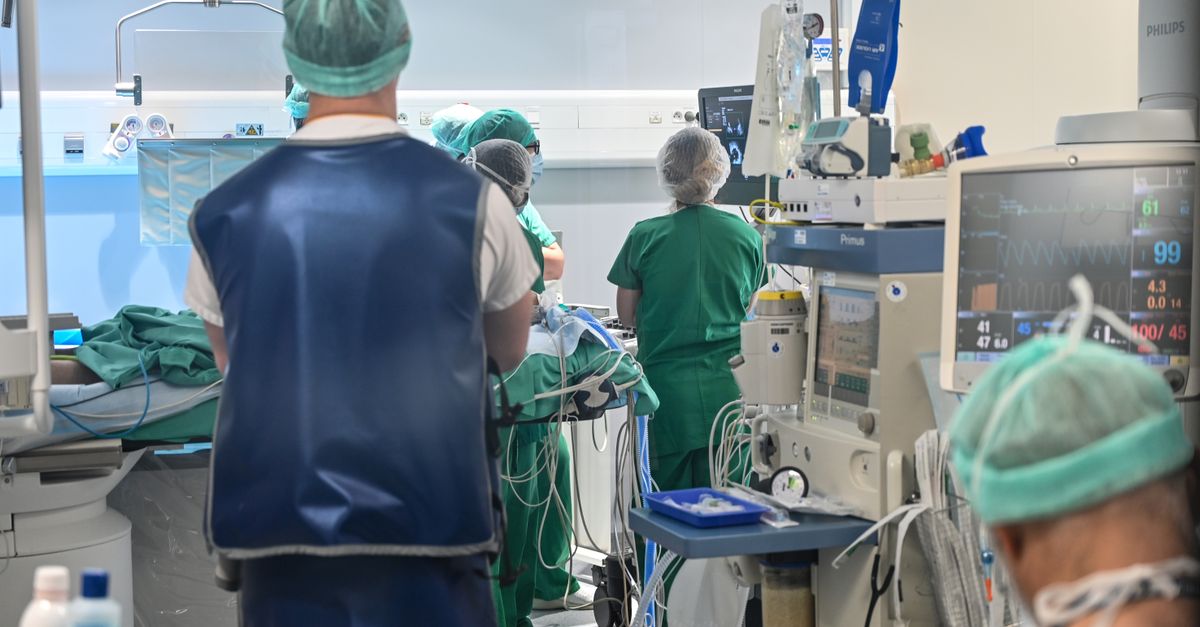 Team of surgeons in an operating room performing a medical procedure, ensuring patient care.