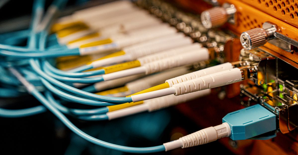 From above of optical switch equipment with many similar connectors with rubber cables and metal parts