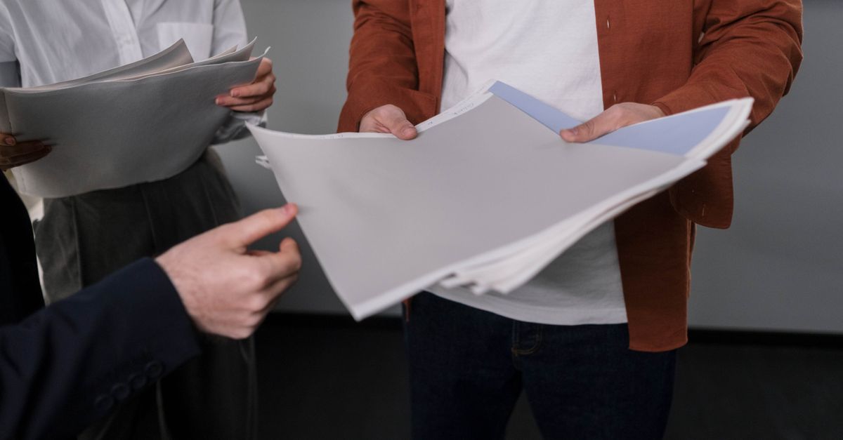 Business professionals discussing interior design samples during a project meeting.