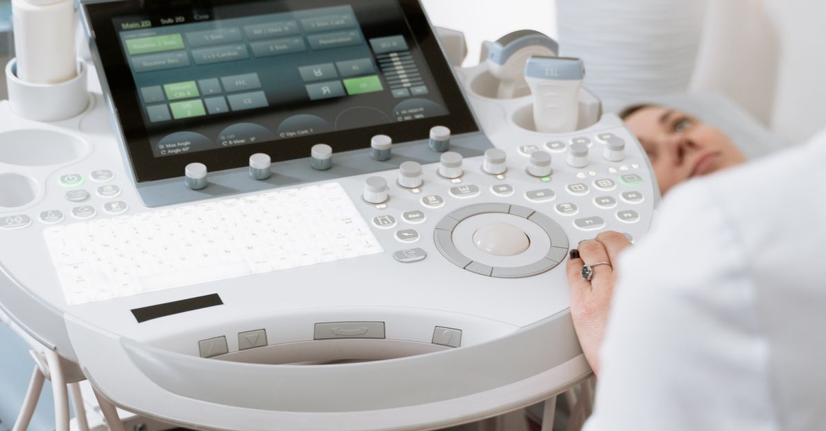 Close-up of a professional conducting an ultrasound examination in a modern medical clinic.