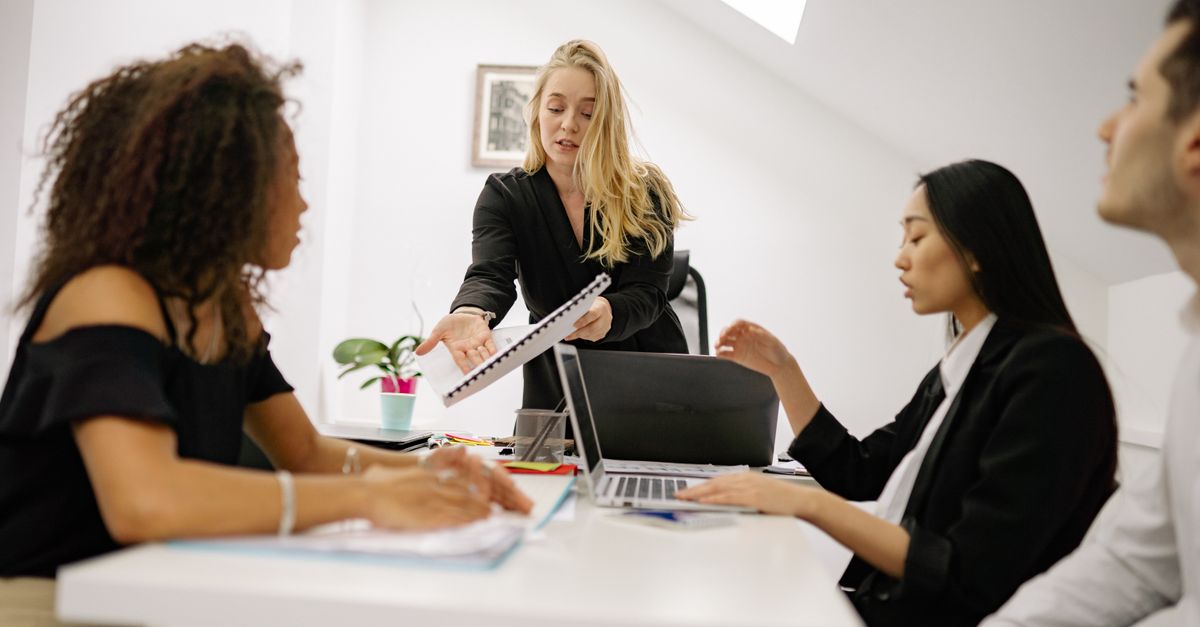 Diverse team engaged in a business meeting, collaborating and discussing ideas.